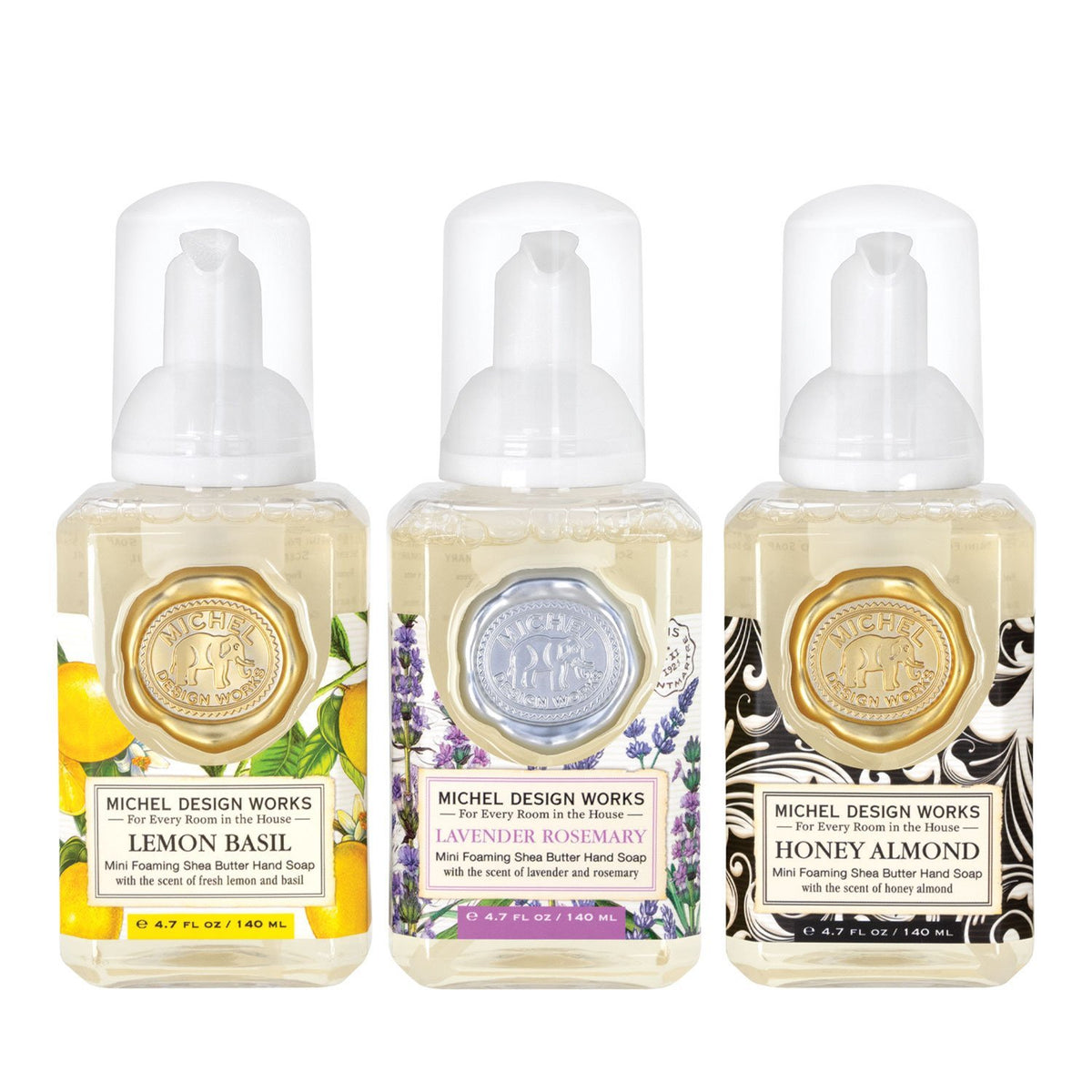 Set of three mini foaming soap dispensers in complementary scents with a compact rectangular silhouette.
