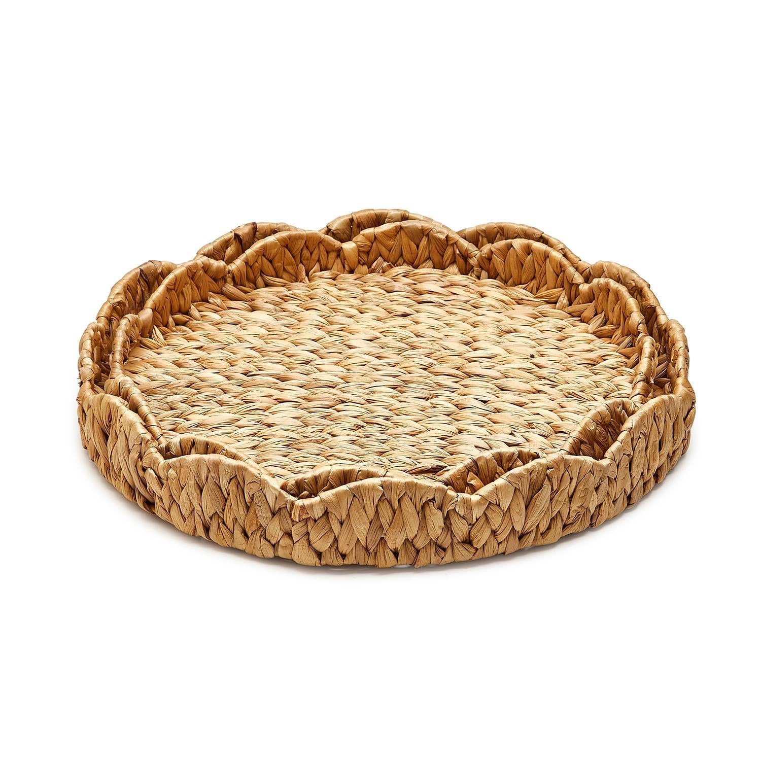 Round scalloped-edge tray made from natural water hyacinth with a light brown woven texture.