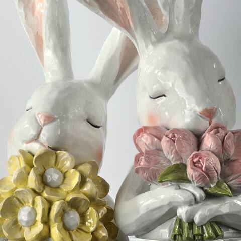 Resin bunny figurine holding flowers with a thoughtful expression