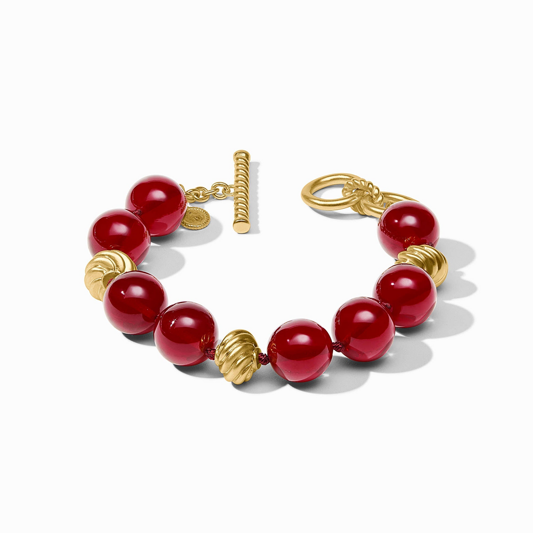 Ravello Bracelet with red resin beads and 24K gold-plated accents featuring a toggle closure.
