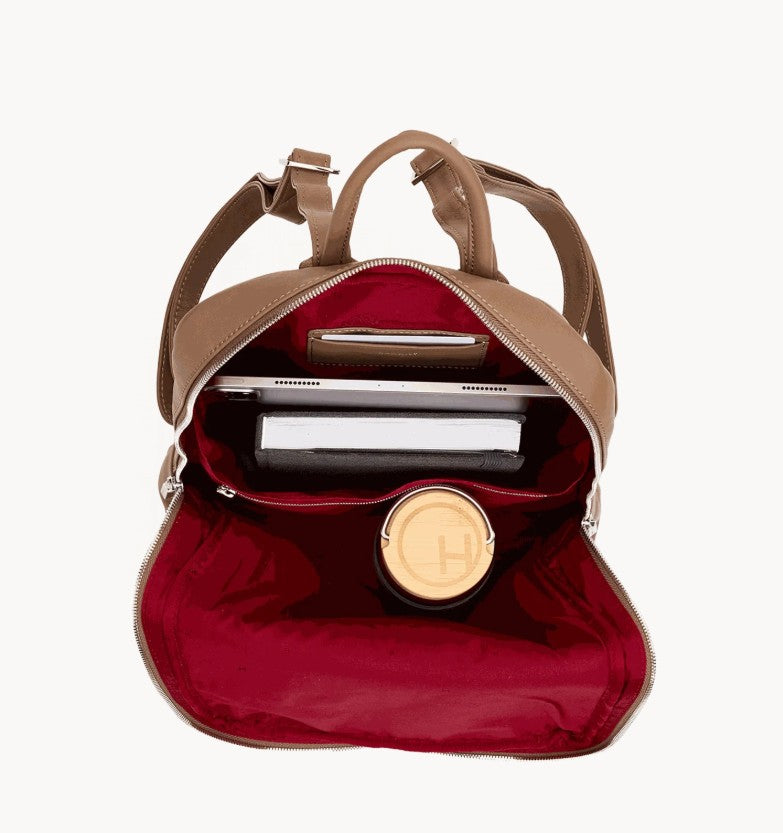 Open Hunter Backpack Large in Dune leather with red lining, holding a laptop, book, and bottle.