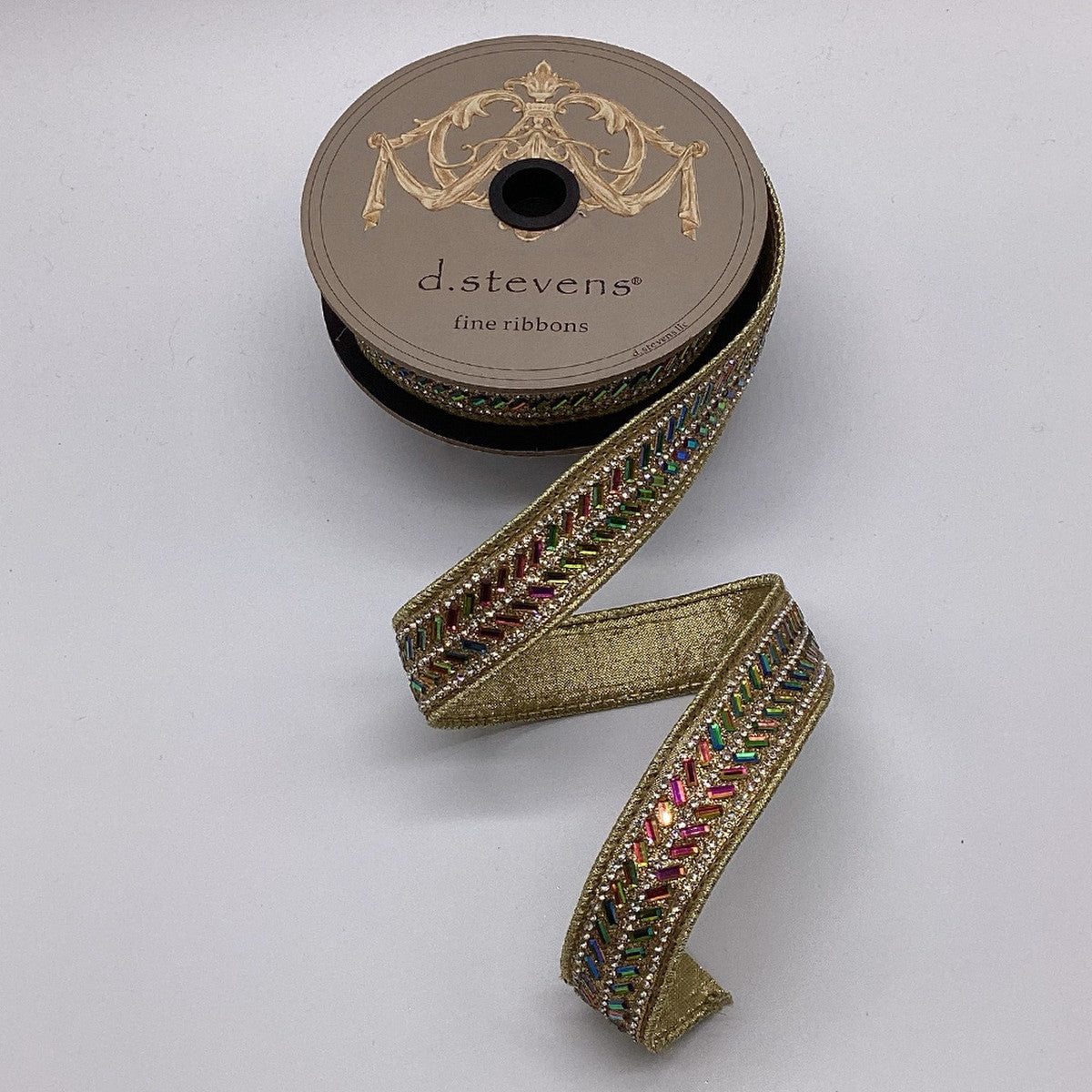 1 inch gold metallic dupion ribbon with a colorful iris herringbone beaded center trim on a spool.