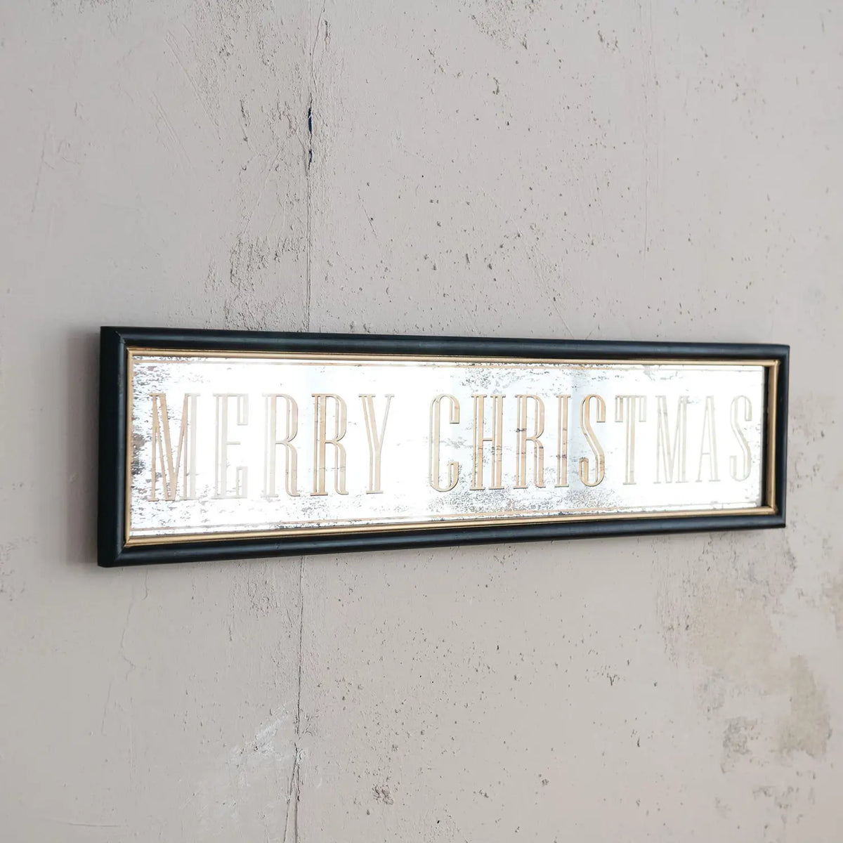 MDF wall décor featuring an antiqued mirror with 'Merry Christmas' text in a festive silhouette.