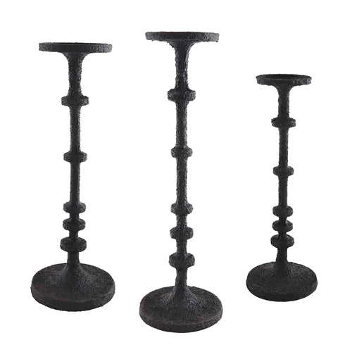 Black metal candlesticks with a sleek cylindrical silhouette.