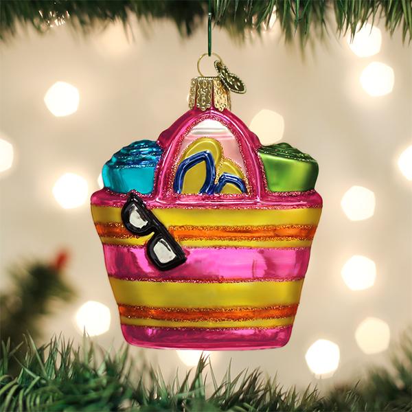 Beach Bag Ornament featuring pink and yellow stripes with sunglasses, flip flops, and towels.