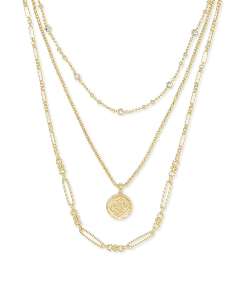 Triple strand gold necklace featuring a custom medallion coin pendant on lobster claw closure.