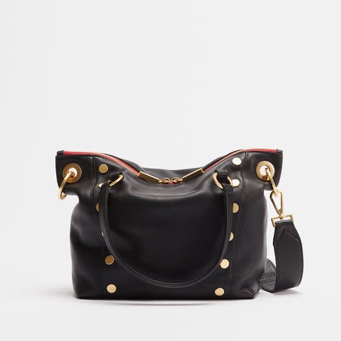 Daniel medium leather satchel bag in tan with brushed gold hardware, double-zippered pocket, and adjustable crossbody strap.