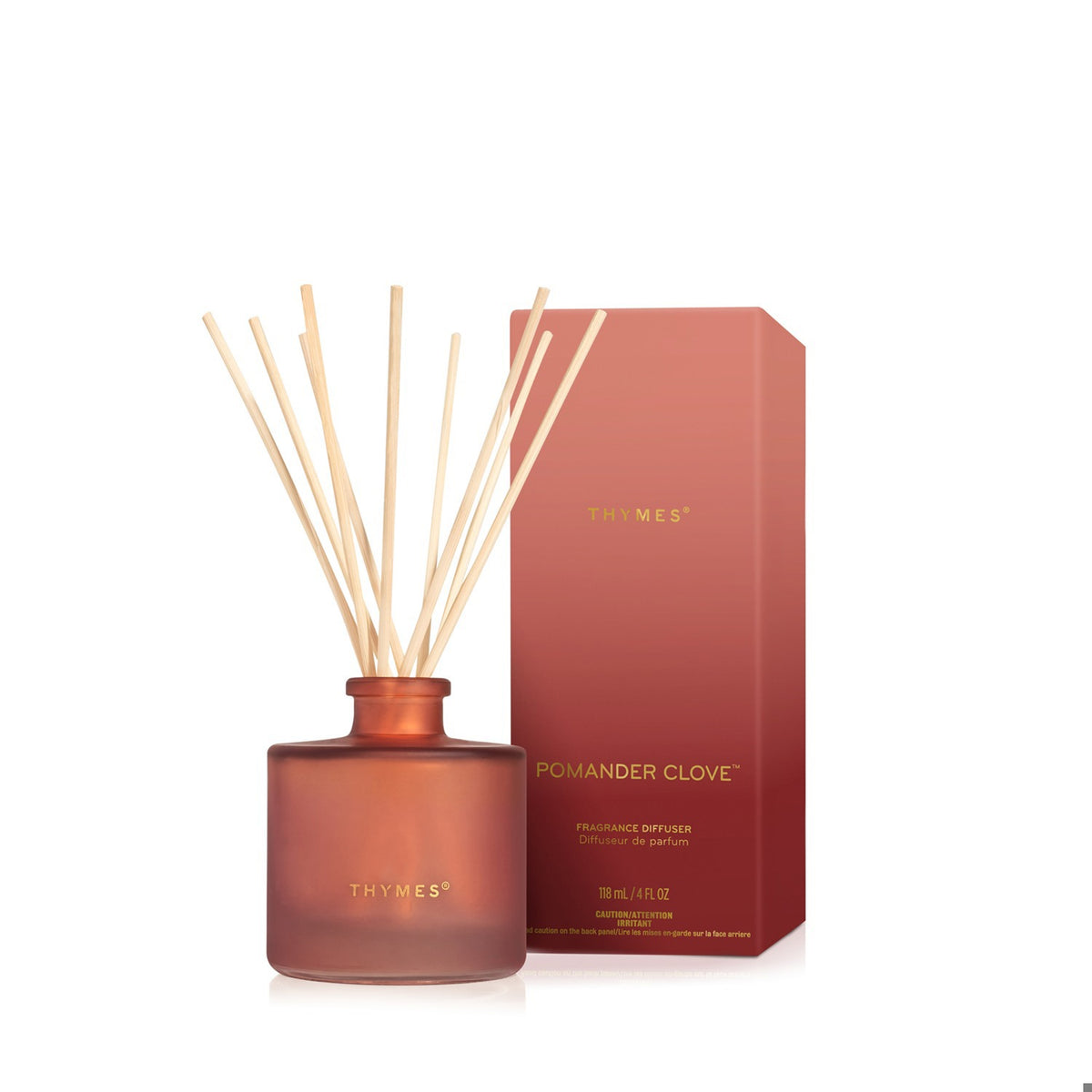 Pomander Clove Petite Diffuser by Thymes in a frosted amber glass bottle with natural reeds.