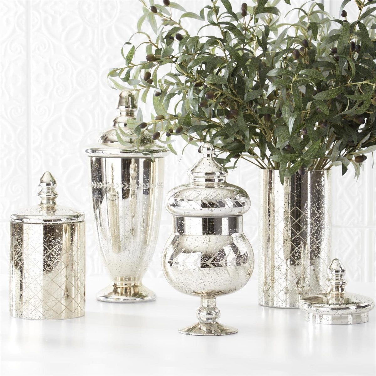 Mercury glass jar with lid featuring a reflective silver finish.