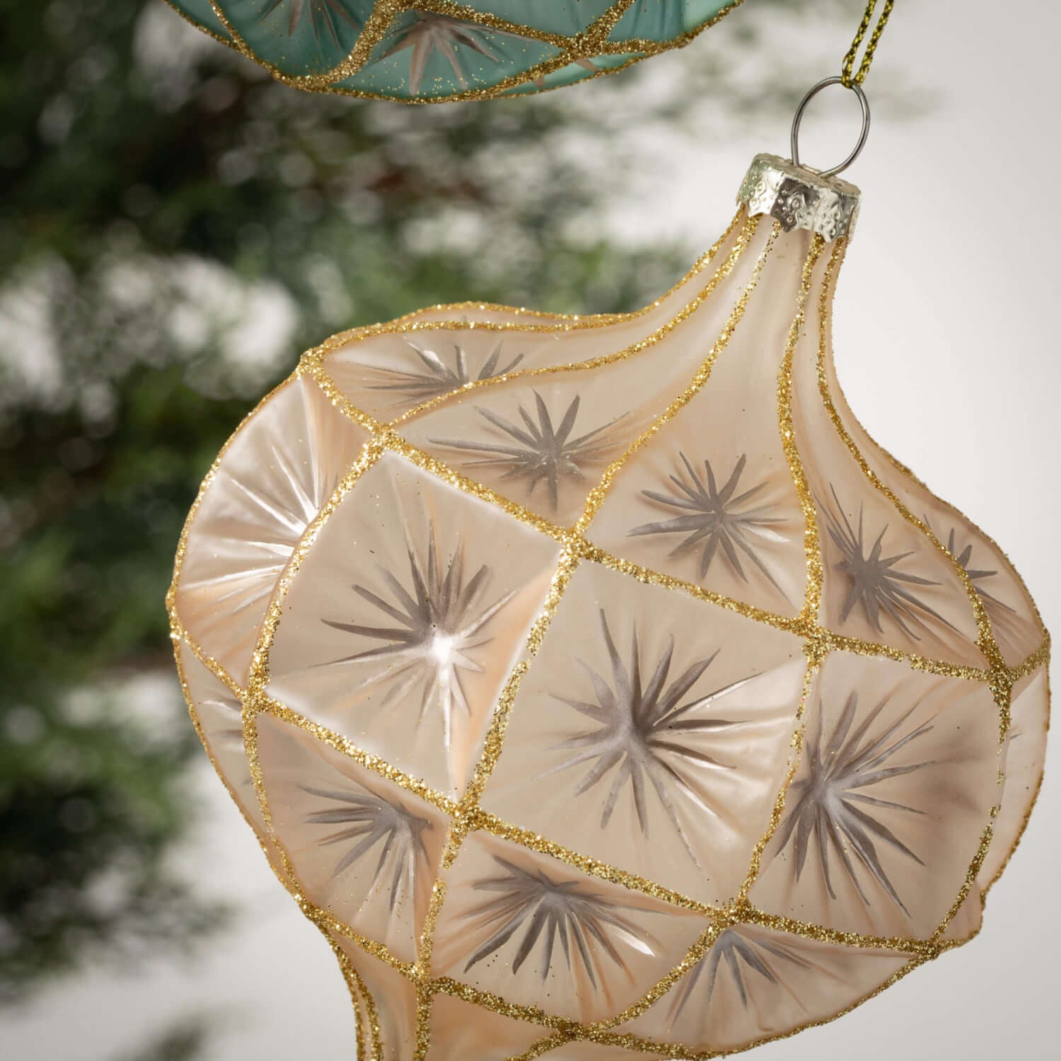 Gold mercury glass ornament with an onion dome shape featuring a vintage-inspired reflective finish.