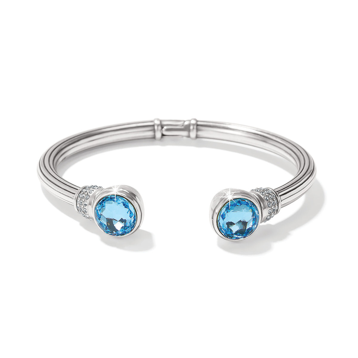 Silver hinged bangle featuring hand-set European crystals in an aqua hue with pave crystal accents.