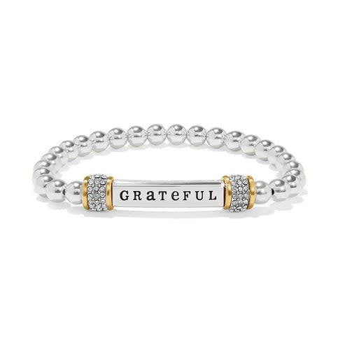 Silver and gold two-tone stretch bracelet with 'Grateful' engraved text on a silver band.