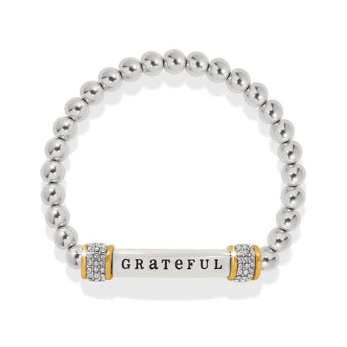Two-tone silver and gold stretch bracelet with 'Grateful' engraved text on a delicate band.