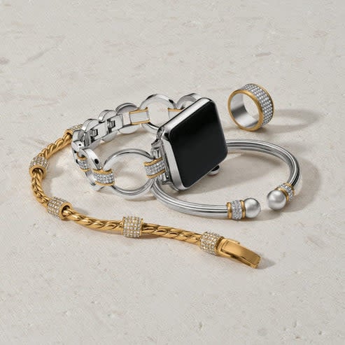 Silver-gold two-tone watch band with pave crystal alternating links on a fold-over clasp.