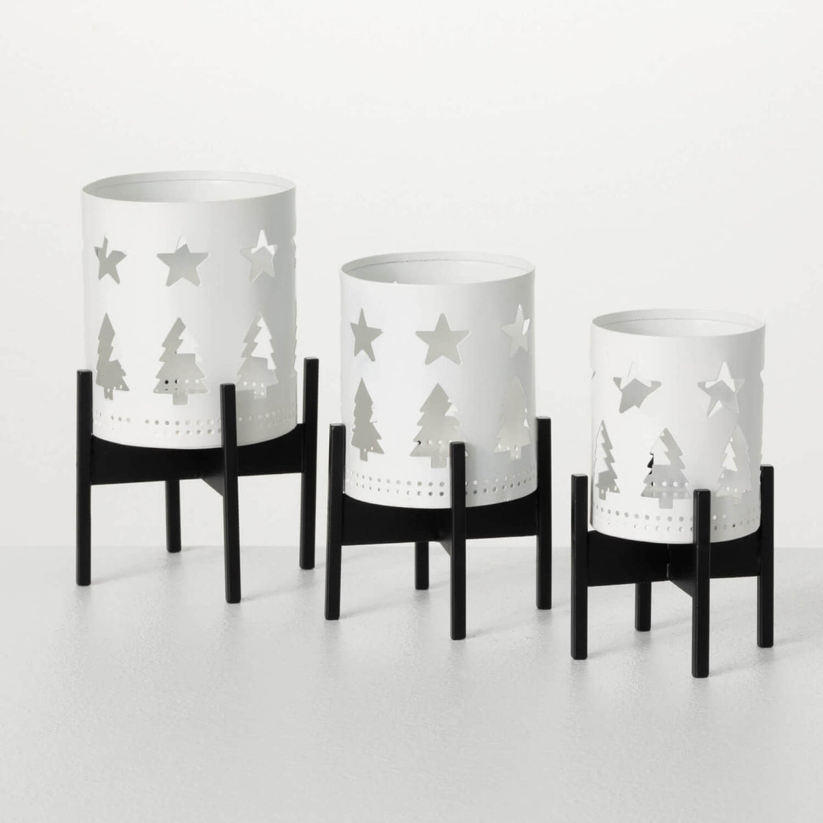 White ceramic candleholder with cutout geometric patterns