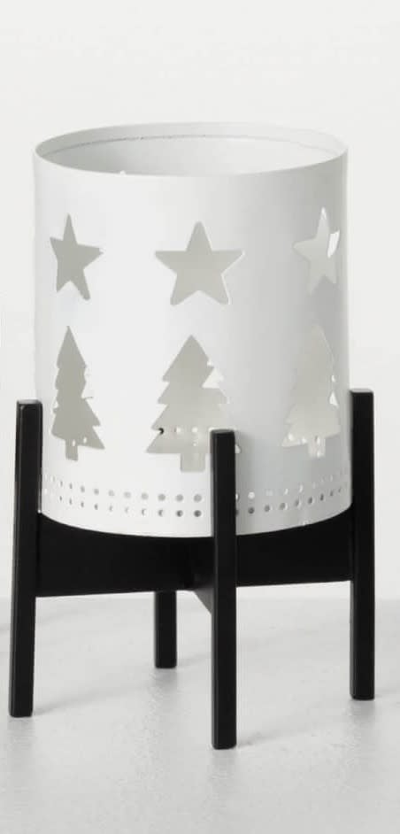 White ceramic candleholder with cutout geometric patterns