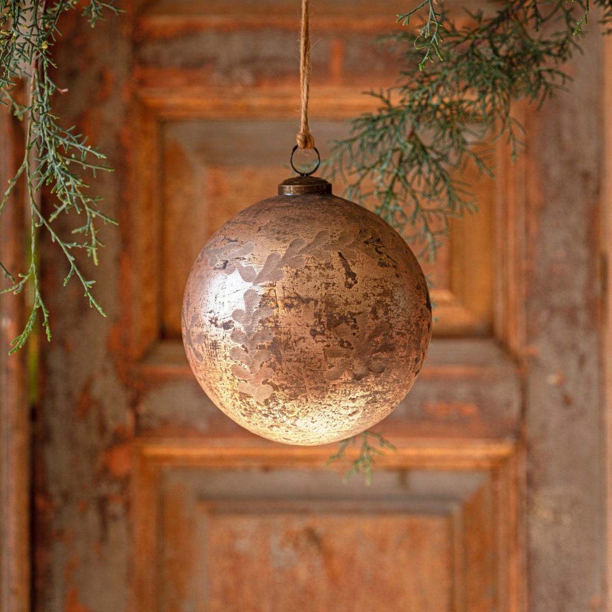 Antique foil glass etched ball ornament with a round silhouette.