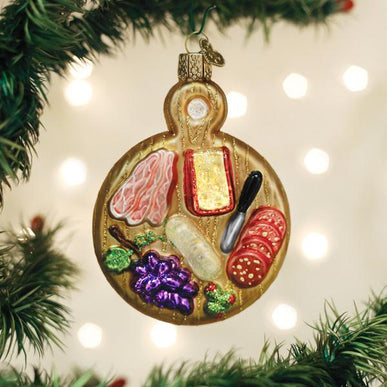 Wooden Christmas ornament shaped like a rectangular charcuterie board with cheese slices.