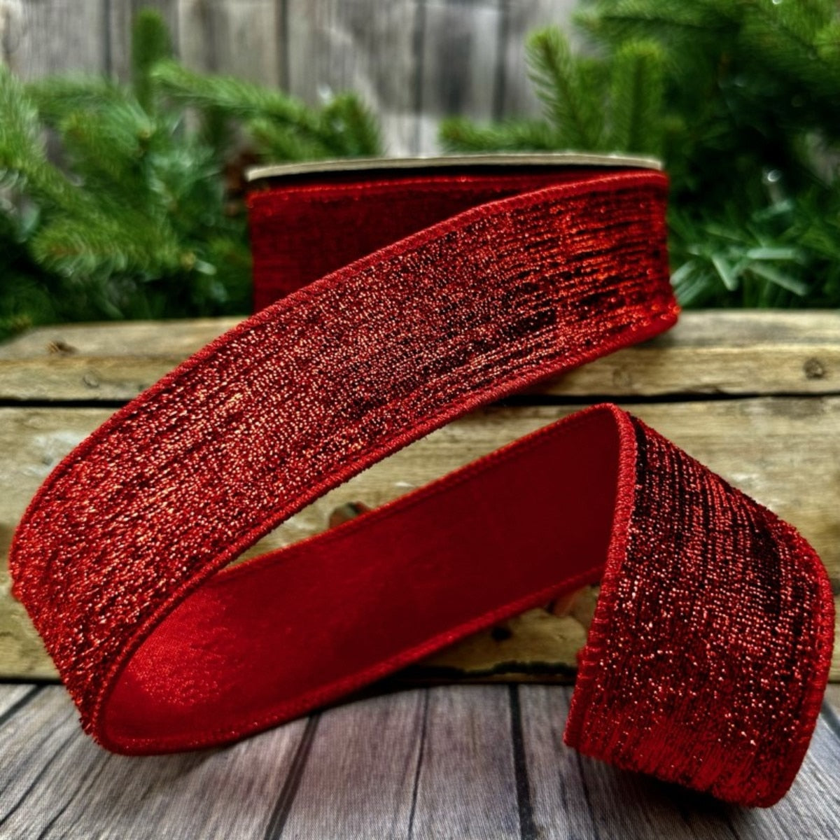 Red metallic velvet fabric roll with matching metallic backing