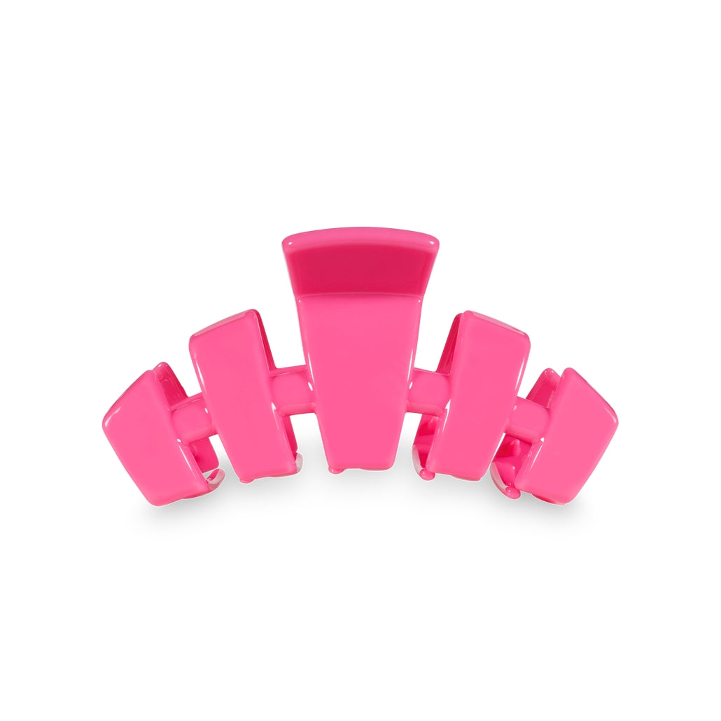 Small classic hair clip with bendable teeth in a neutral tone.