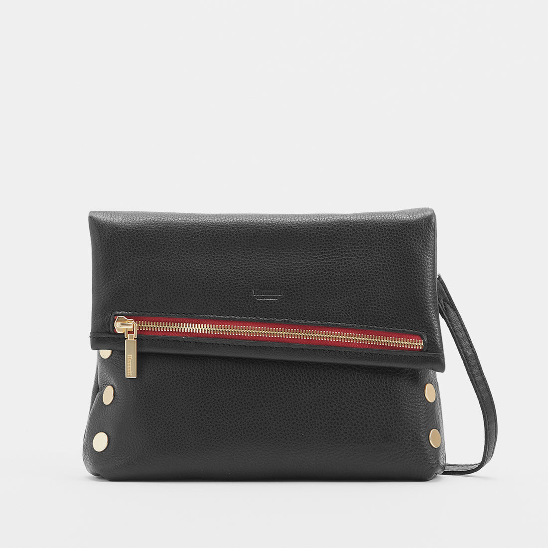 Medium zippered bag in buttery black leather with brushed gold rivets and a subtle red seam detail.