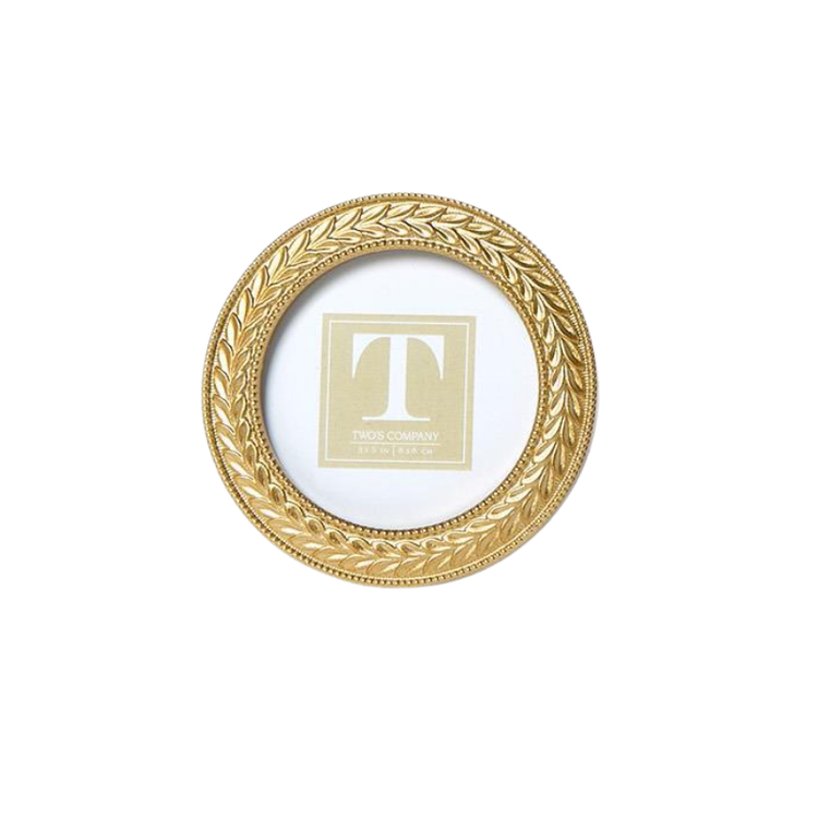 Round gold photo frame with an intricate laurel wreath design and beaded edges.