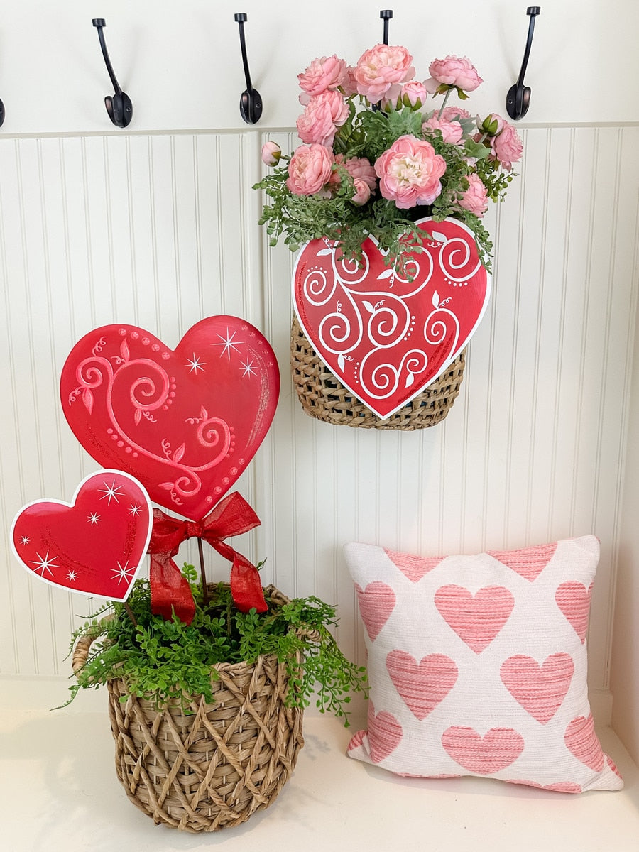 Stakeable heart-shaped ornament with a swirl sparkle finish in red.