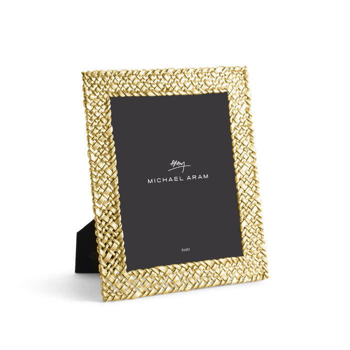 Antique goldtone palm leaf frame with sculpted textures in vertical orientation.
