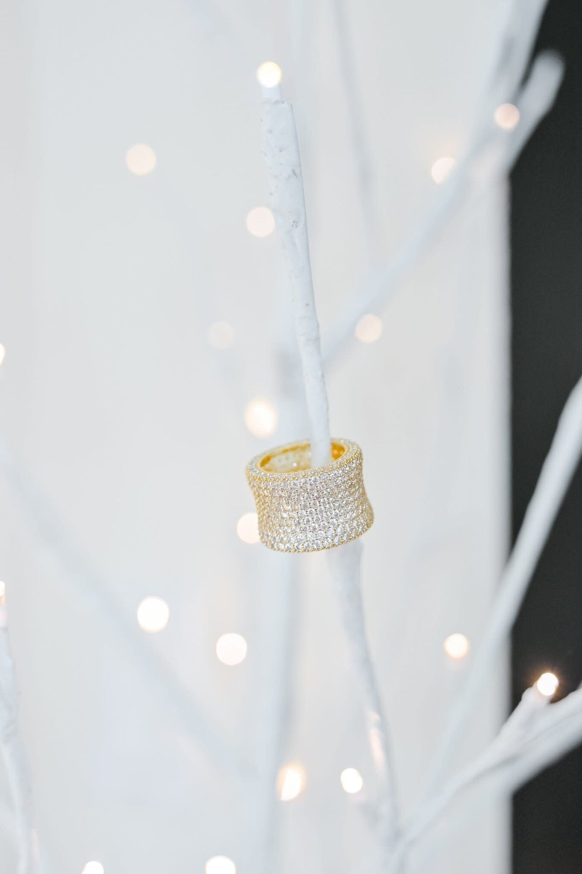 Micropaved cubic zirconia eternity ring with a continuous band of sparkling stones in silver-toned metal.