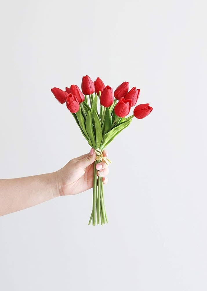 Bundle of three black polyurethane tulips with green leaves on a white background