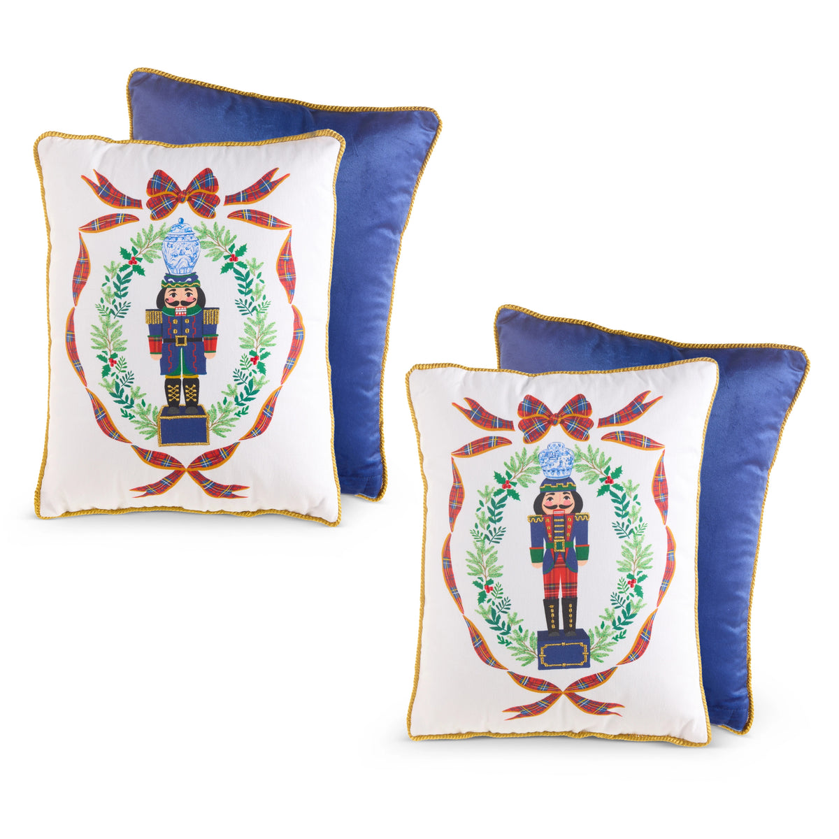 Two 16-inch white pillows with nutcracker designs and blue velvet backs, sold individually.