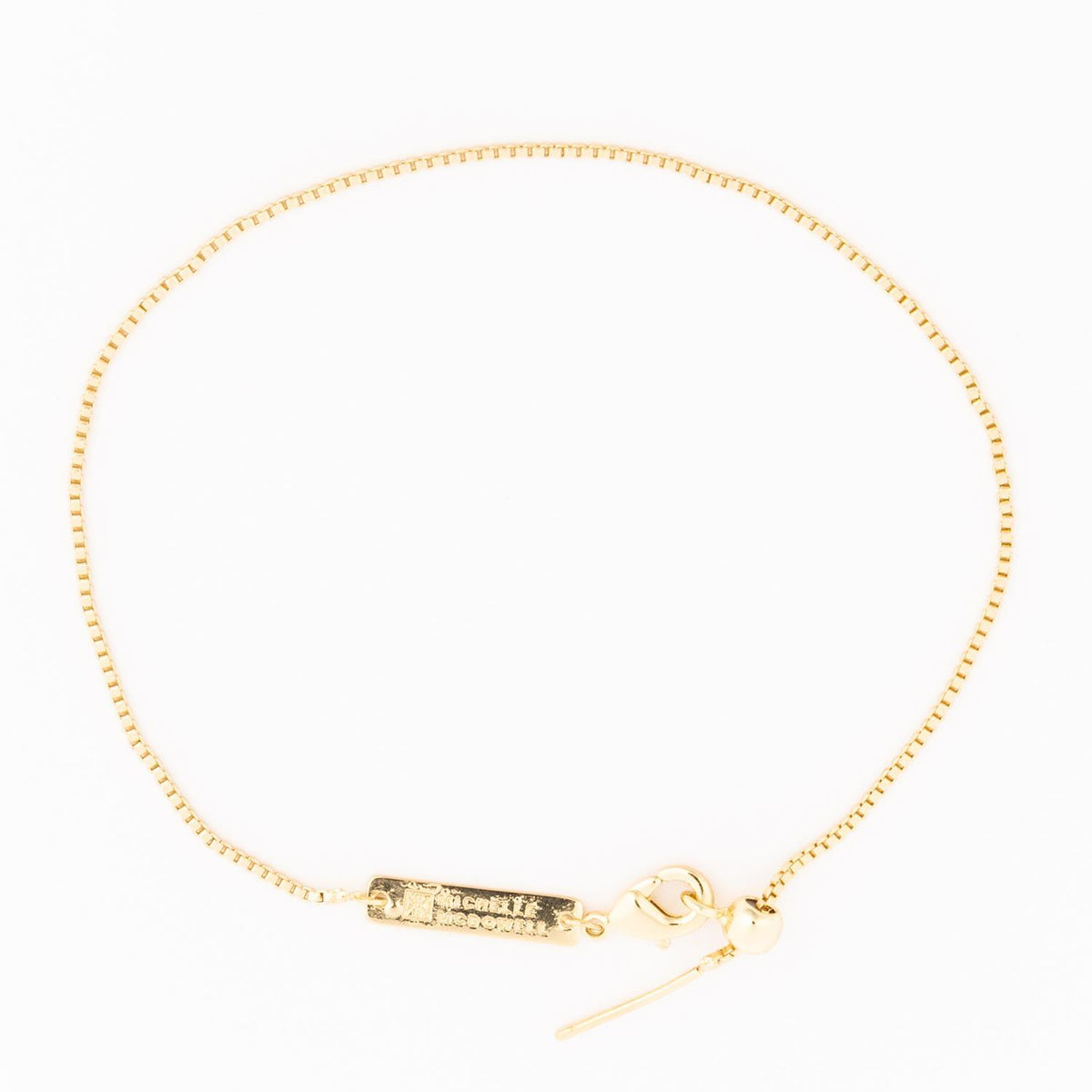 Sylvie Gold Bracelet, a delicate gold box chain with an adjustable slider clasp and logo tag.