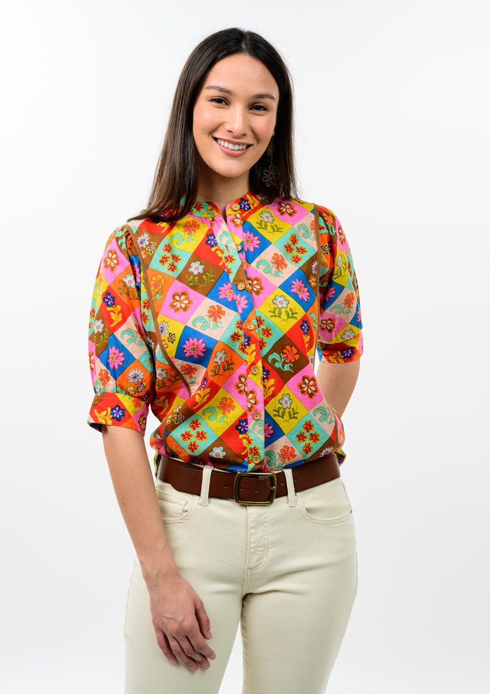 Woman wearing the Denise Block Patch Floral Top, a colorful patchwork button-up with short sleeves.