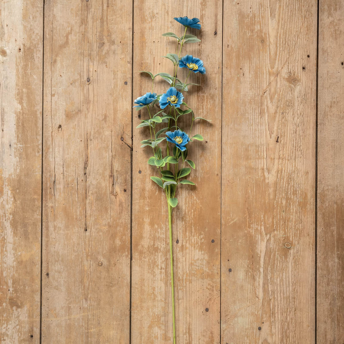 34-inch artificial anemone spray with plastic stems and polyester petals in white.