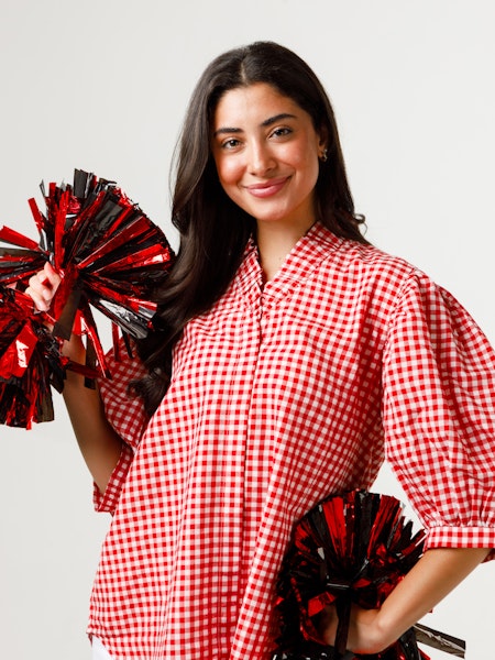 Laura Top in white cotton poplin with ruffled stand collar, covered placket, and pleated sleeves.