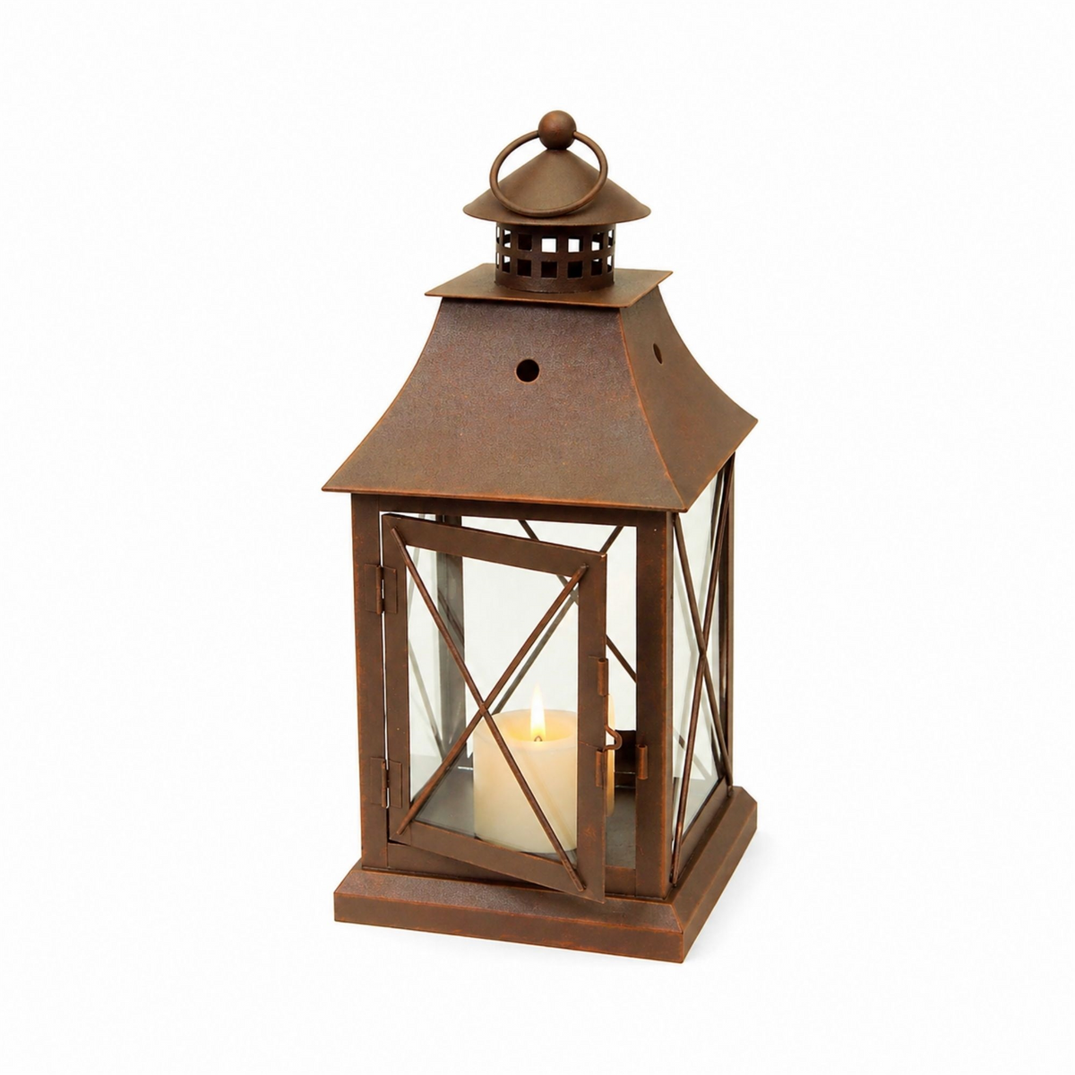 Rustic brown metal decorative lantern with a lit pillar candle inside and a ring handle on top.