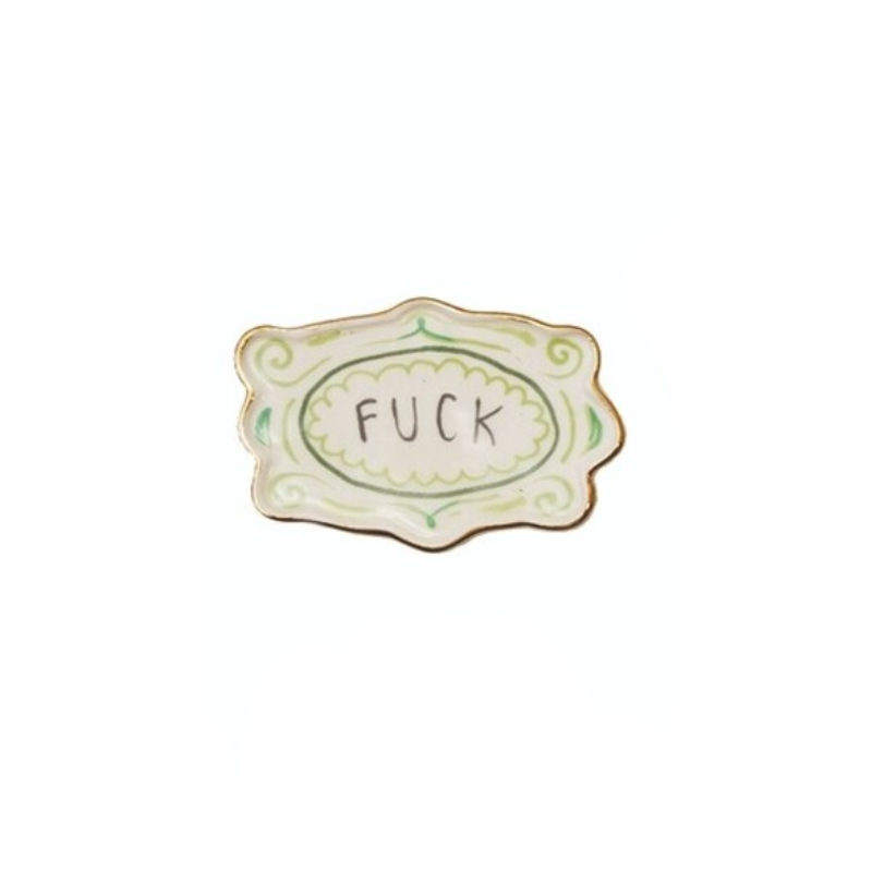 Small white stoneware magnet with gold trim and green accents featuring the word "FUCK".
