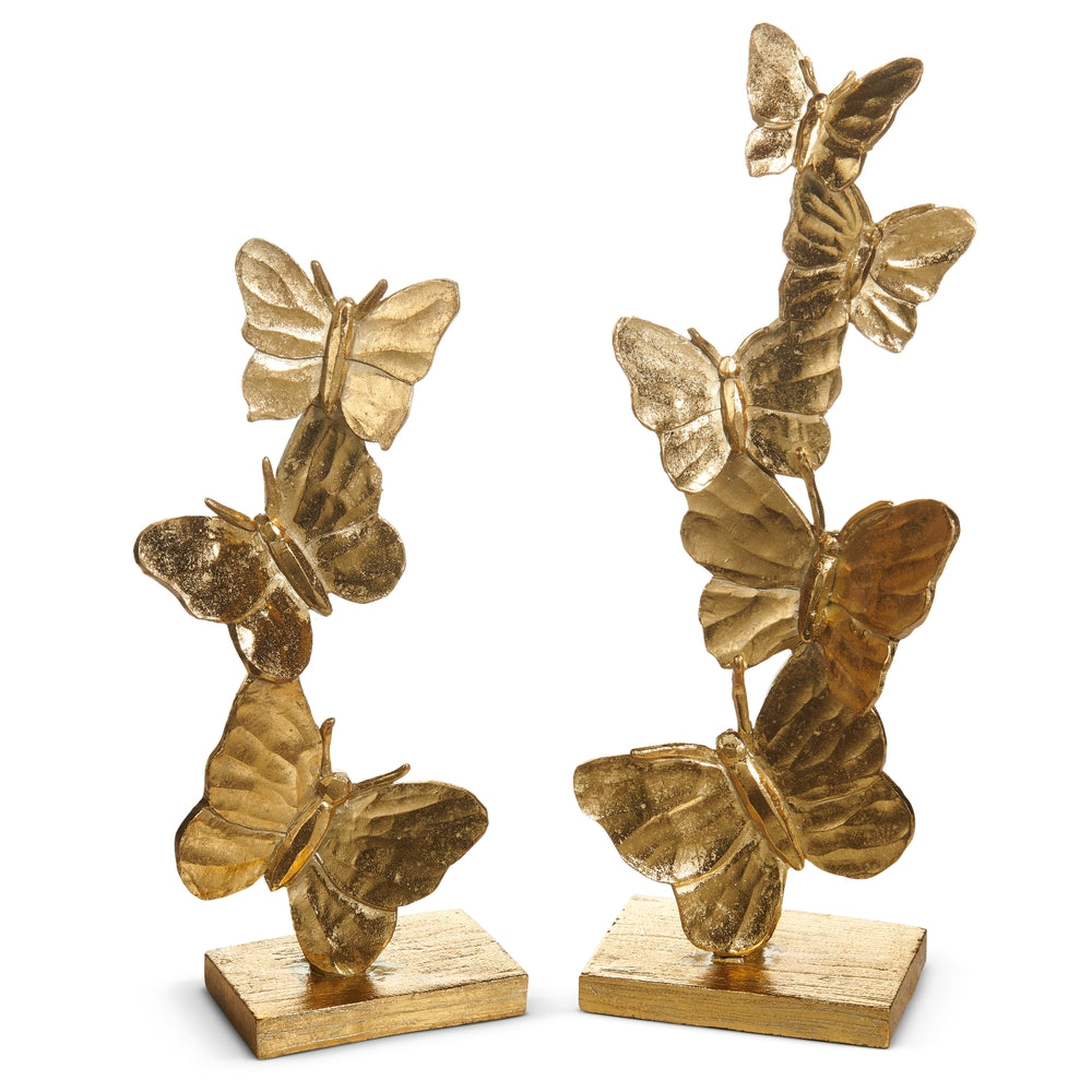 Stacked gilded butterfly wall decor on a stand made of natural stone powder in gold and neutral tones.