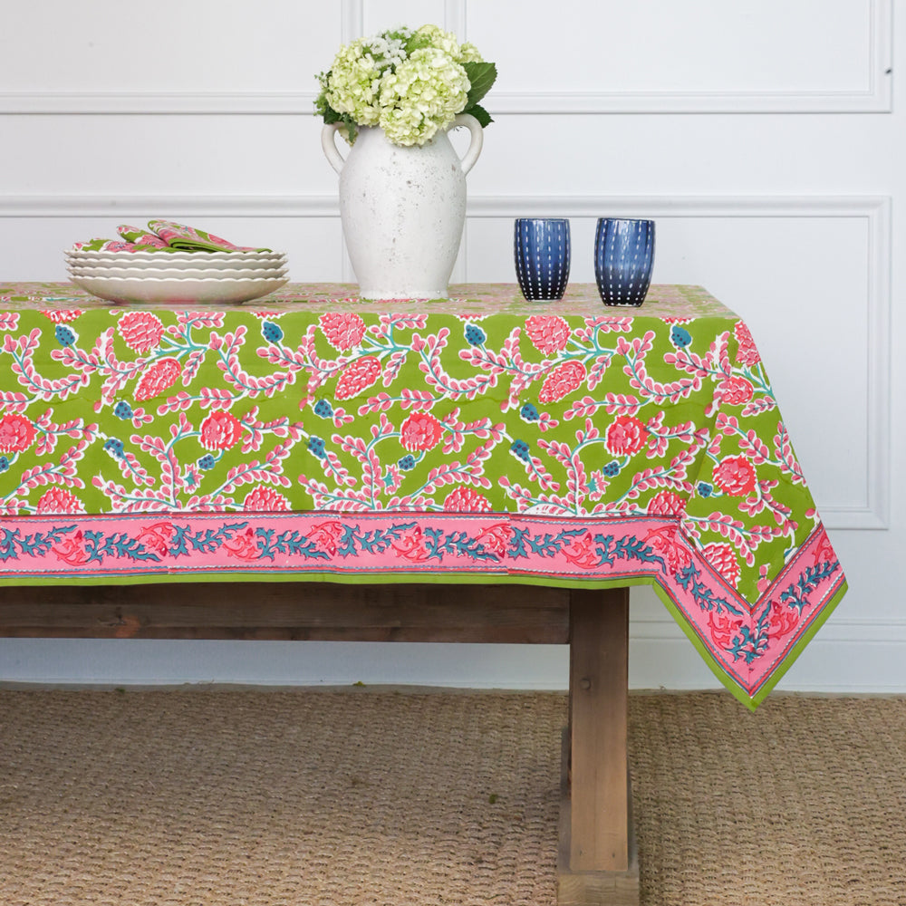 Palm Beach Pinecone tablecloth in natural cotton with a subtle pinecone pattern and rectangular silhouette.