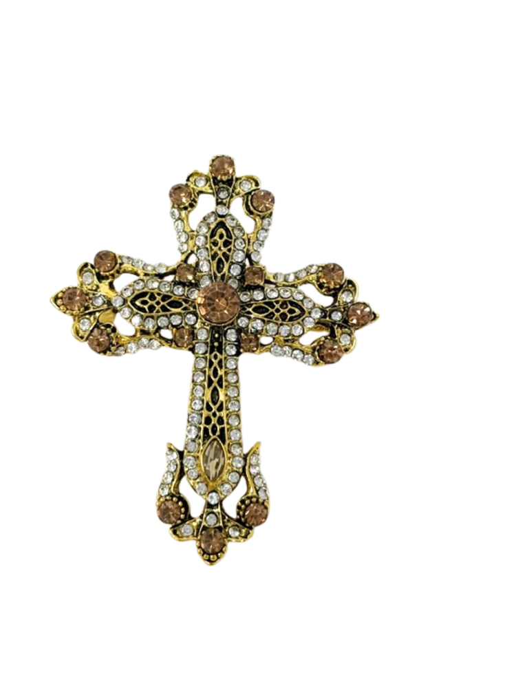 Gold-tone cross brooch with intricate filigree, clear crystals, and amber-colored gemstones.