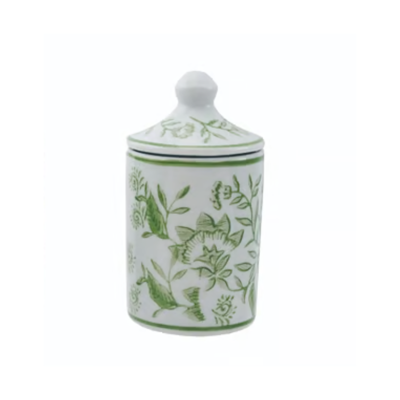 Hand-stamped white stoneware spice jar with green floral patterns and a matching lid.