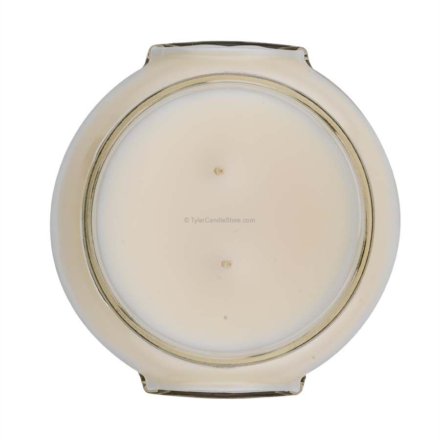 A white ceramic jar containing a Tyler Candle with visible wicks inside.