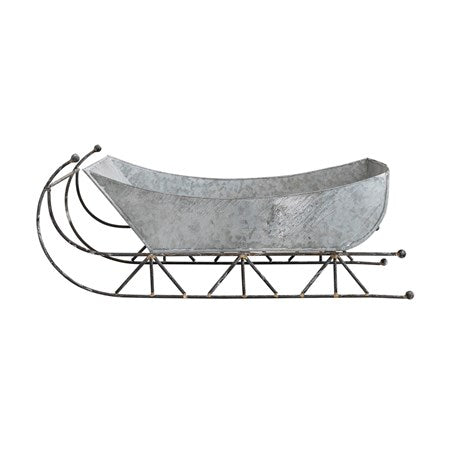 Galvanized metal sleigh with a zinc finish and black metal runners.