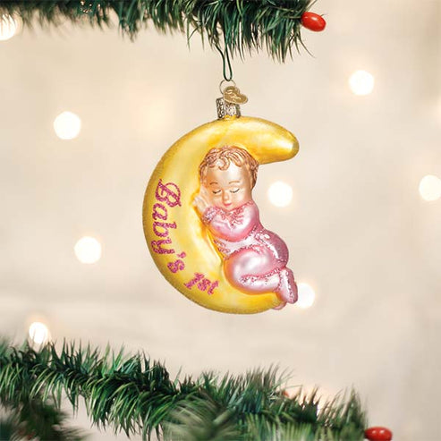 Dreamtime Girl Ornament featuring a sleeping baby in pink pajamas on a yellow crescent moon.