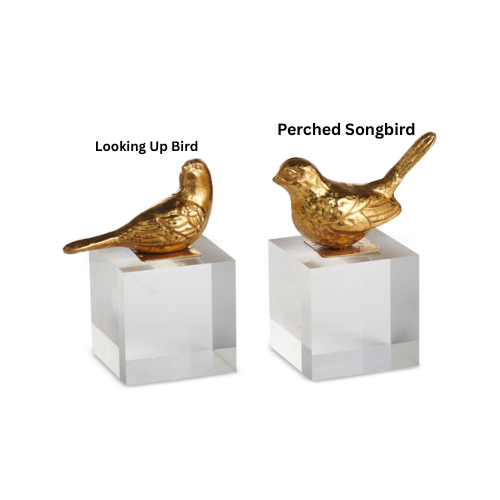 Gold bird figurine on a clear acrylic block base
