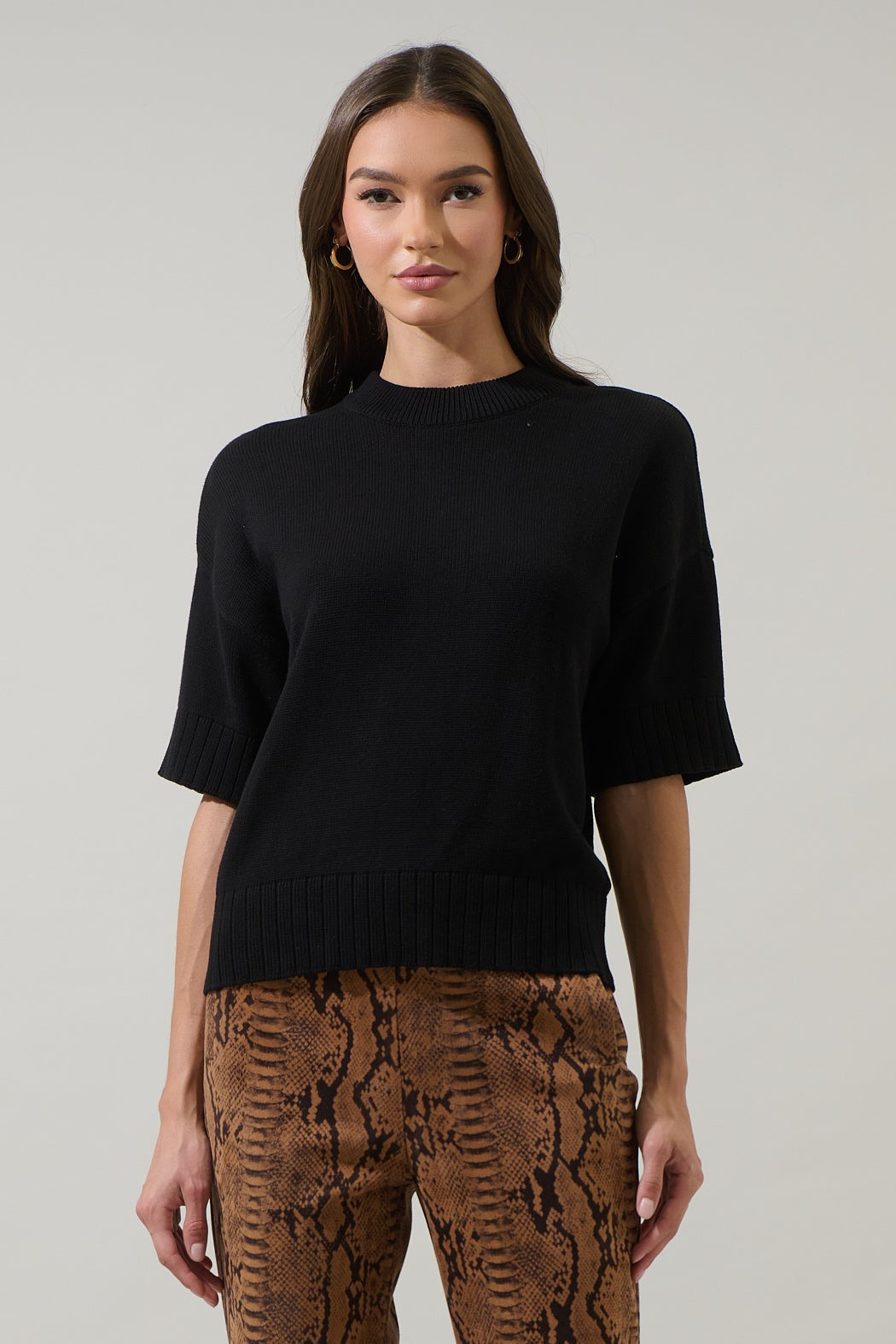 Relaxed fit drop shoulder cotton sweater top in solid color with ribbed detailing.