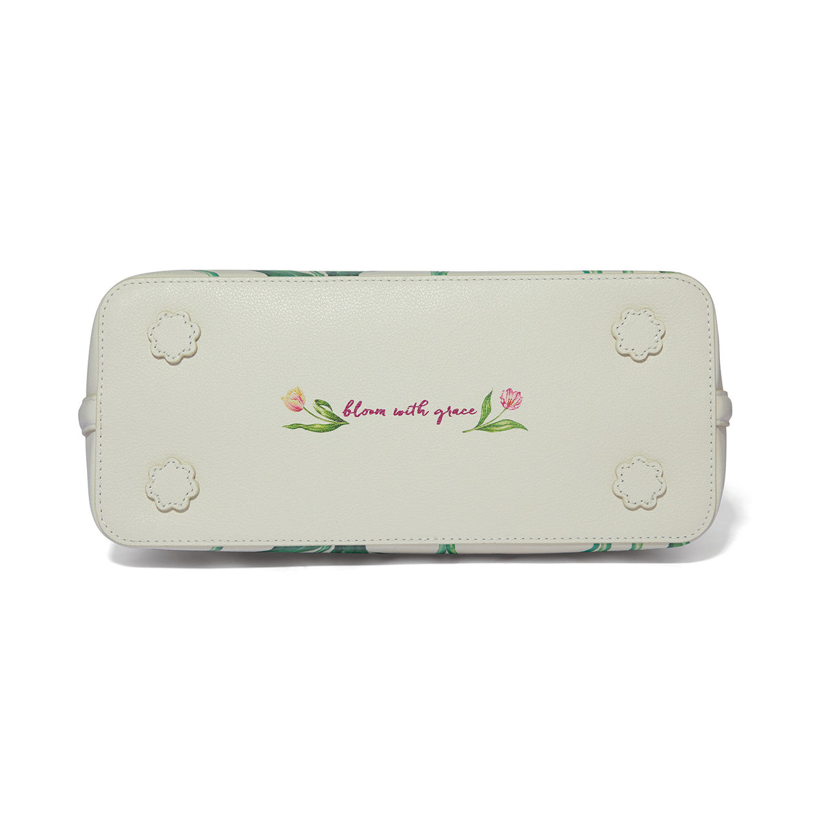 Bottom of a white leather tote bag featuring the message "bloom with grace" and floral accents.