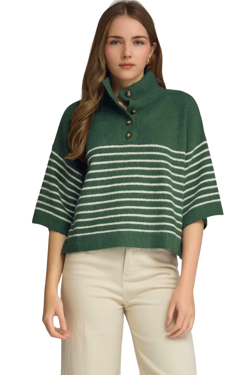 Woman wearing a green and white striped short sleeve knit top with a mock neck and button details.