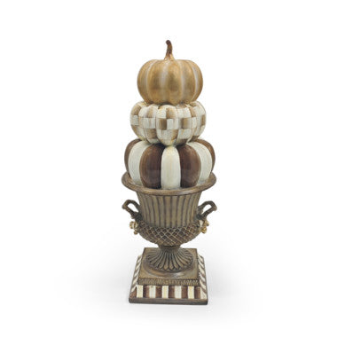Stacked ceramic pumpkins in a dark urn with orange accents