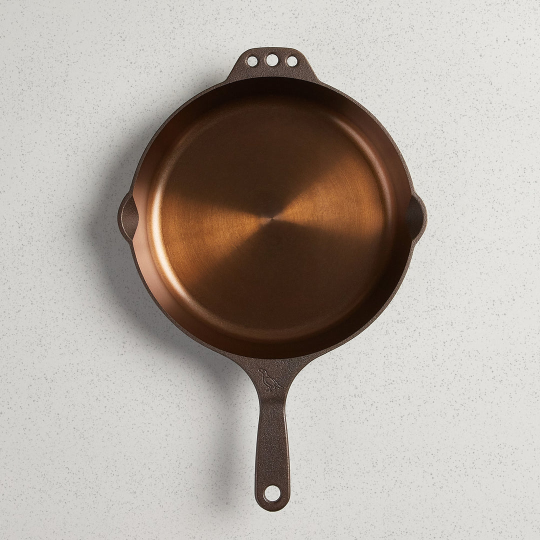Top view of a No. 10 Traditional Skillet with polished interior, pour spouts, and helper handle.